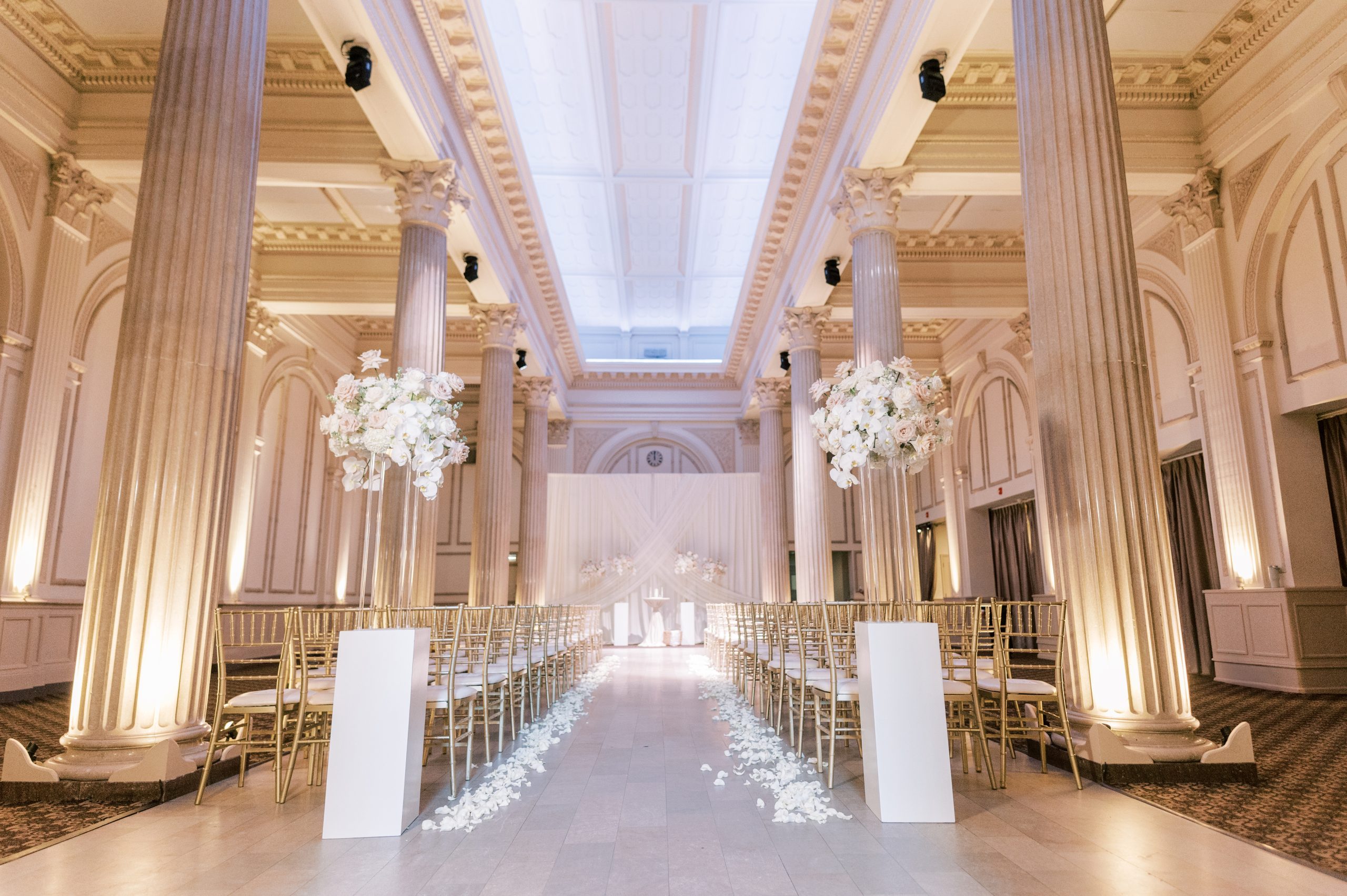 Elizabeth and Kevin's beautiful white and gold ceremony in the ballroom at The Treasury on the Plaza. | Photo: Angelita Esparar