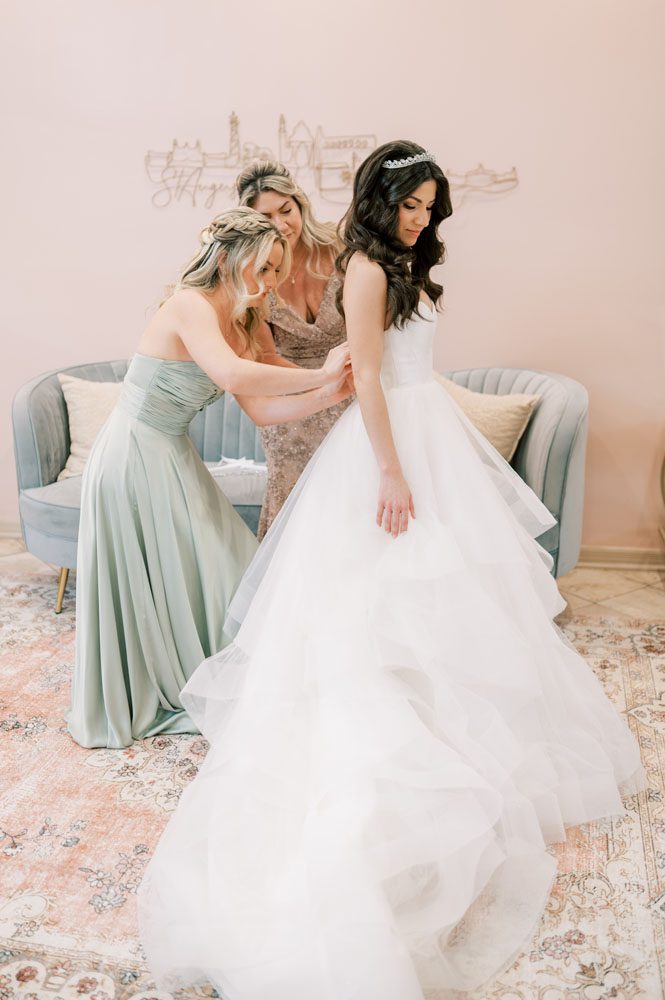 Bride putting on Dress