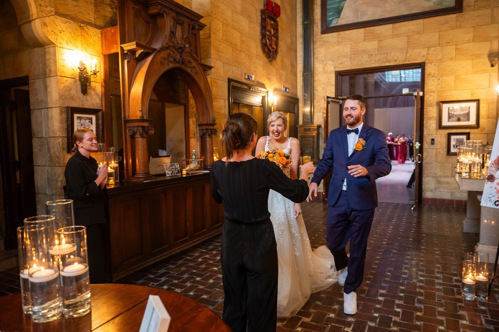 A wedding planner from Coastal Celebrations gives the couple their signature drinks after their ceremony. | Photo: Sky Palm Studios