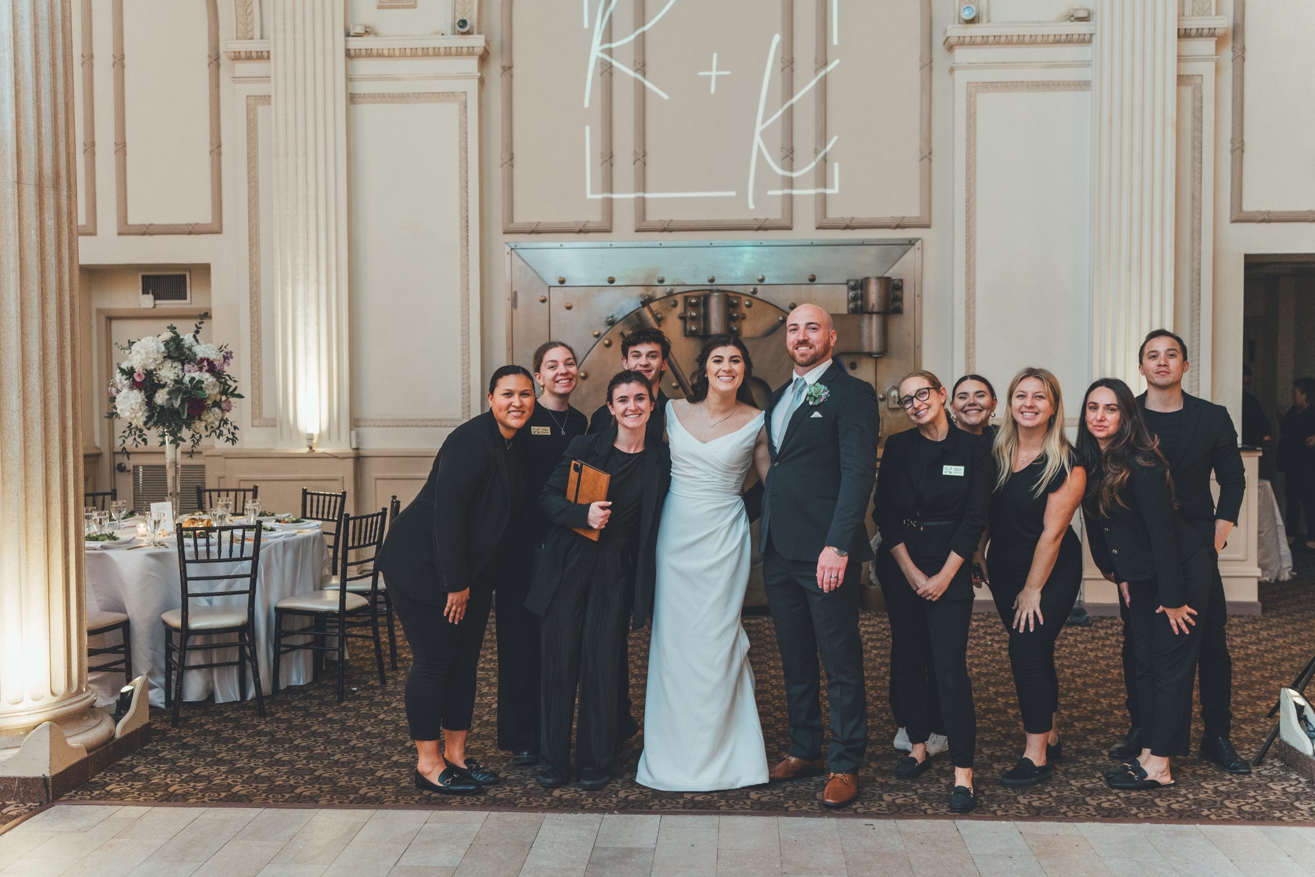 Treasury Venue Collection Team and Coastal Celebrations group photo with the bride and groom before their reception. | Photo: Southern Palms Studio