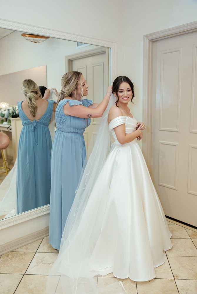 Bride putting on her veil